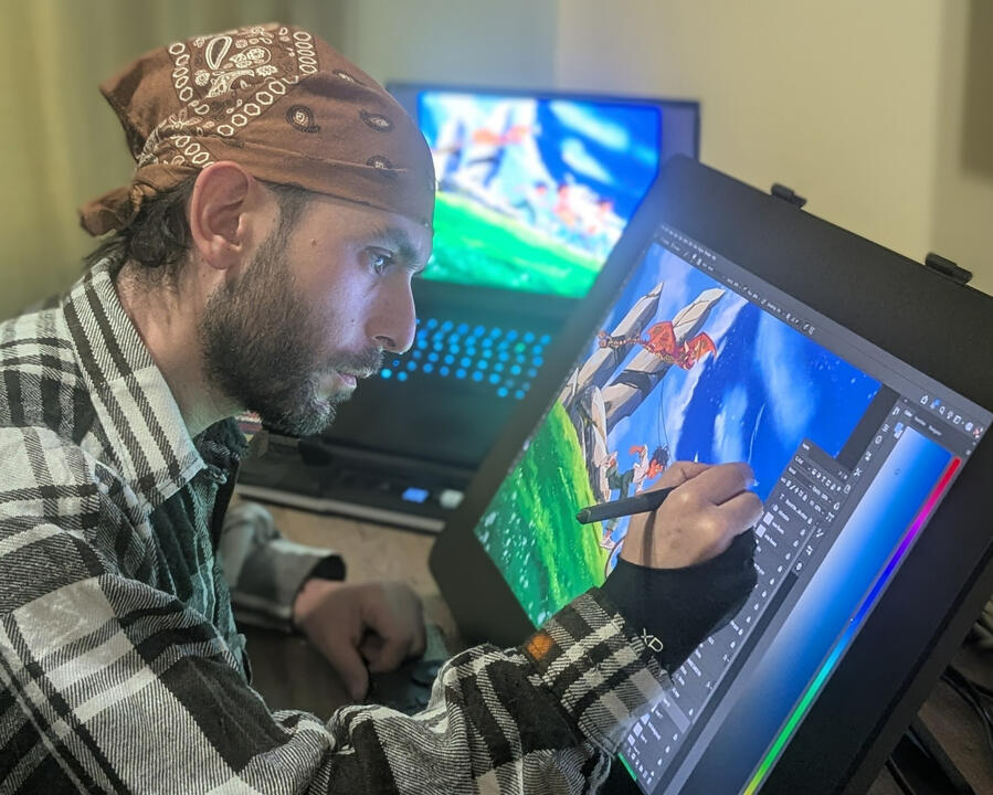 Behind the Illustrations. Narek Saroyan at Work Children’s book illustrator Narek Saroyan working with a stylus on a digital drawing display, painting a colorful scene of children racing downhill with a dragon kite.